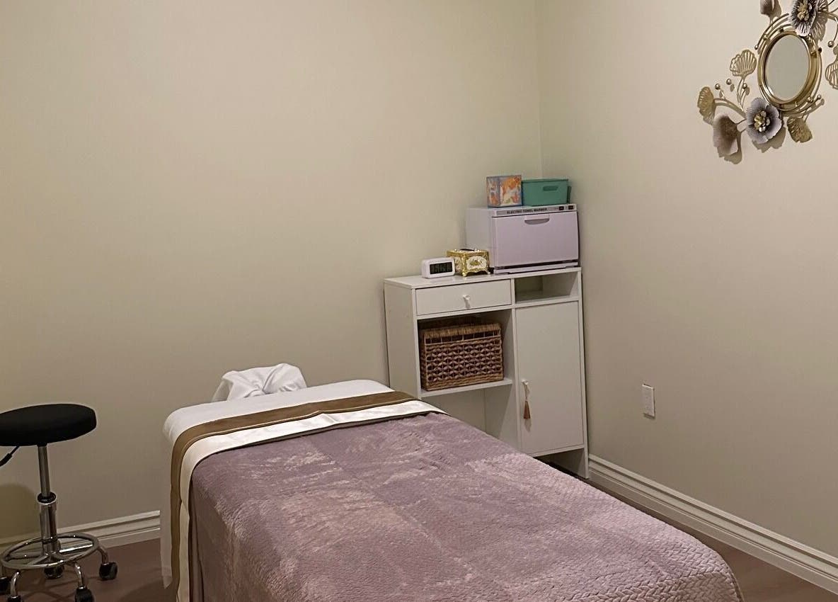 Cozy massage room at The Point Wellness and Spa in Tarzana, California, US, featuring soft lighting and elegant decor.