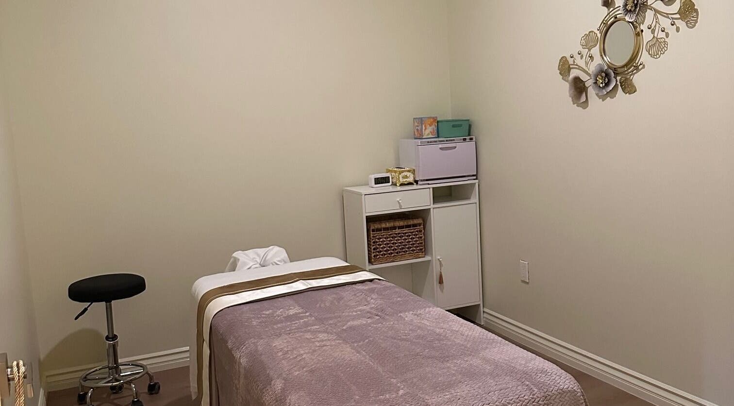 Cozy massage room at The Point Wellness and Spa in Tarzana, California, US, featuring soft lighting and elegant decor.