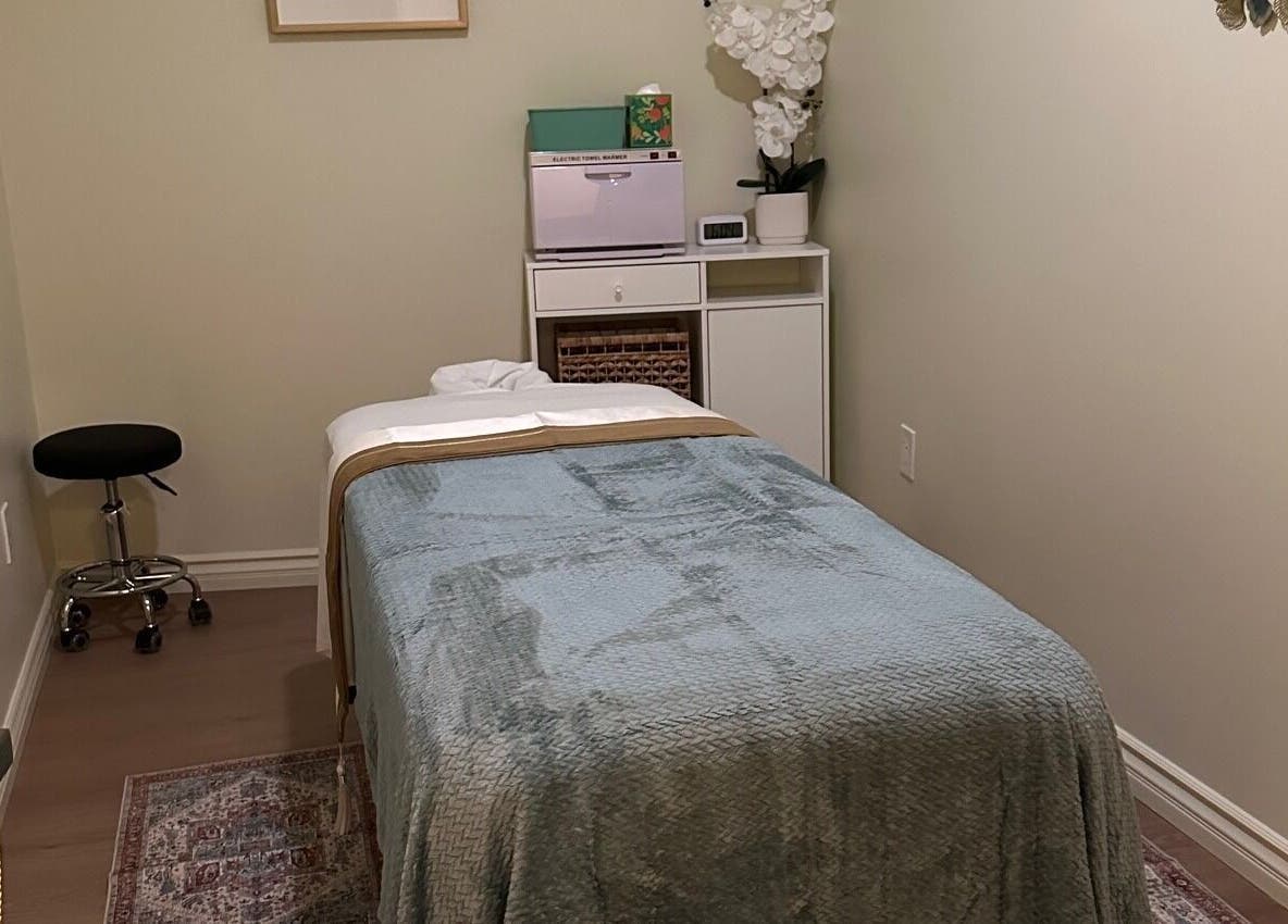 Relaxing massage room at The Point Wellness and Spa, Tarzana, California, US, featuring a cozy treatment bed.