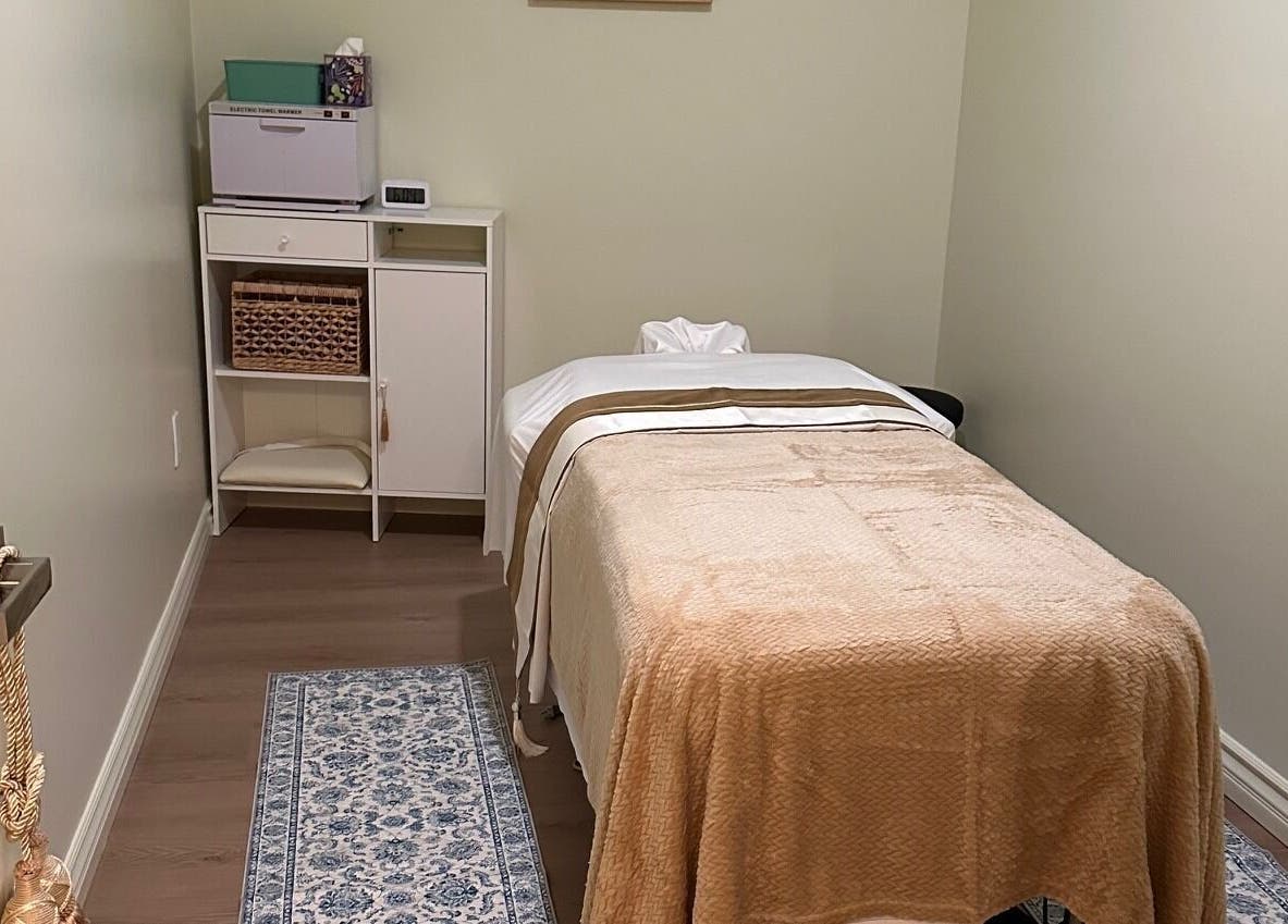 Tranquil massage room in The Point Wellness and Spa, Tarzana, California, US. Cozy table and ambient decor.