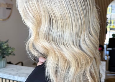 Elegant blonde waves styled at TJJ_Hair, Crawley, England, GB, showcasing luxurious hair texture.