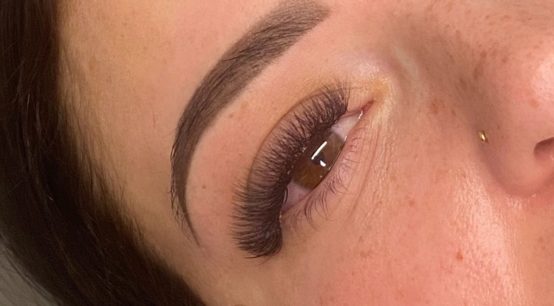 Close-up of eyelash extensions at Trackside Beauty, Melbourne, Victoria, AU, showcasing perfectly styled thick lashes.