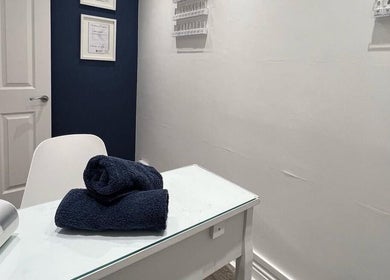 Cozy nail salon setup at NailsByMaria, featuring a white table and navy towel. Location: Torquay, England, GB.