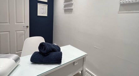 Cozy nail salon setup at NailsByMaria, featuring a white table and navy towel. Location: Torquay, England, GB.