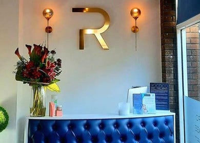 Reception area at NailsByMaria, Torquay, England, GB, featuring modern decor and vibrant flowers.