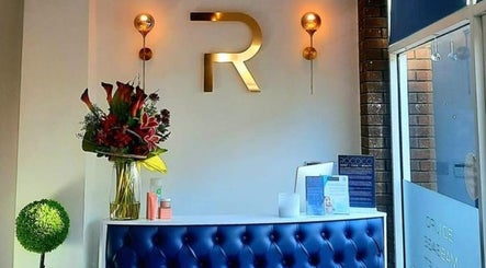 Reception area at NailsByMaria, Torquay, England, GB, featuring modern decor and vibrant flowers.