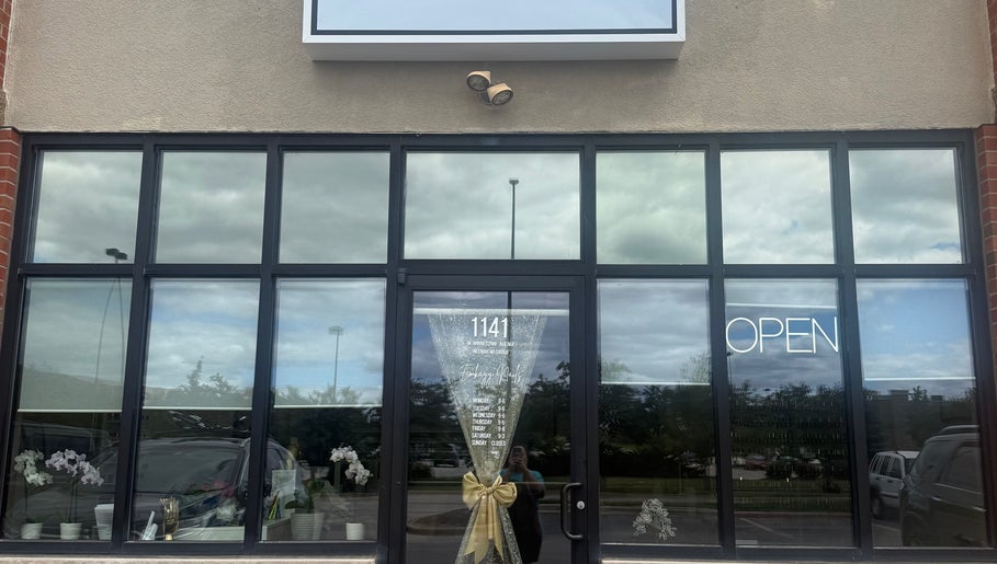 Front entrance of Emkayy Nails, Neenah, Wisconsin, with glass doors and 'Open' sign.