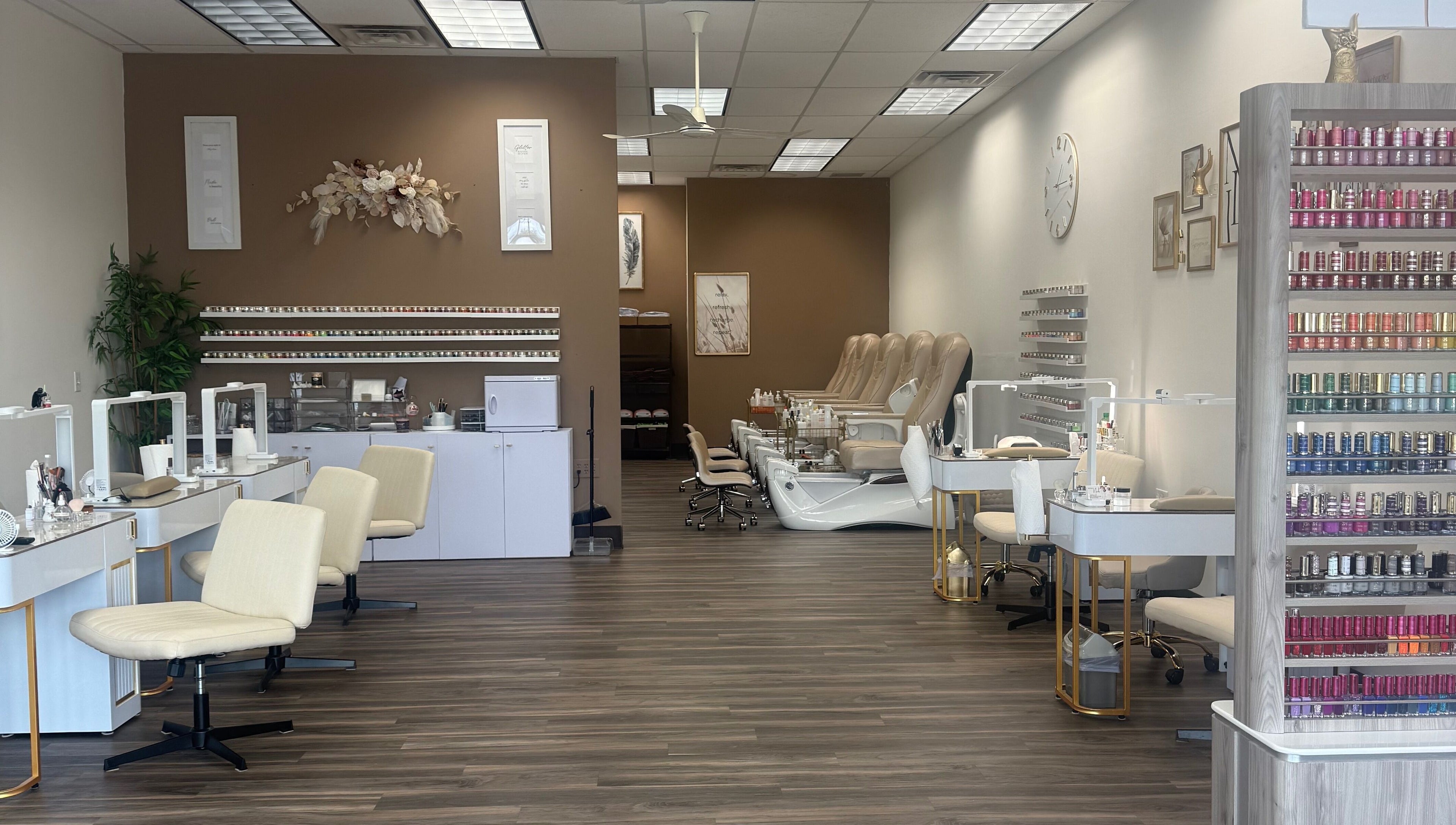 Elegant interior of Emkayy Nails, Neenah, Wisconsin, US, showcasing nail stations and pedicure chairs.