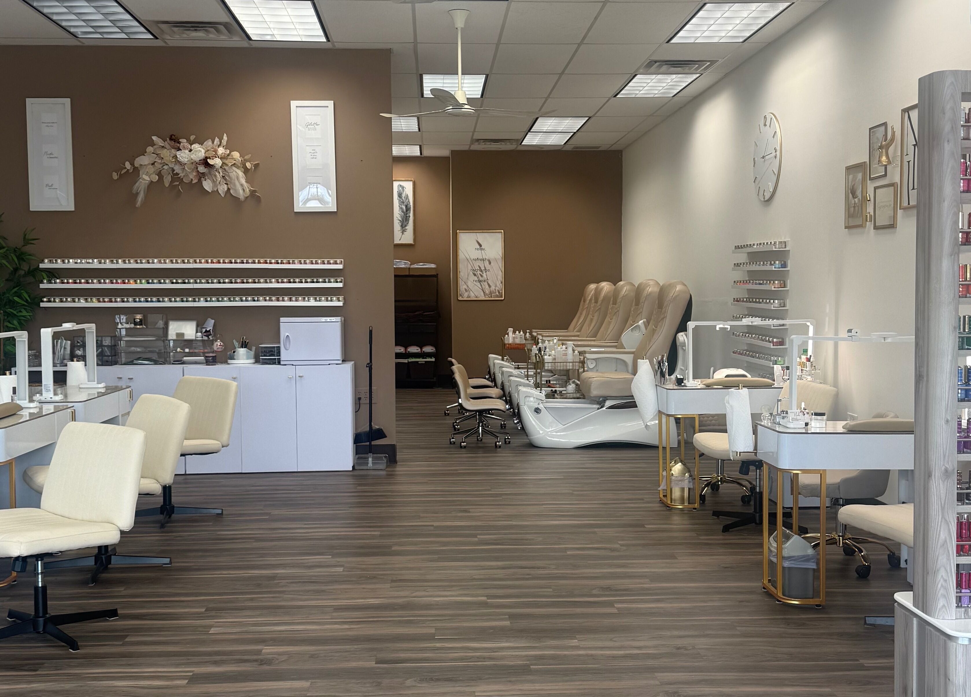 Elegant interior of Emkayy Nails, Neenah, Wisconsin, US, showcasing nail stations and pedicure chairs.