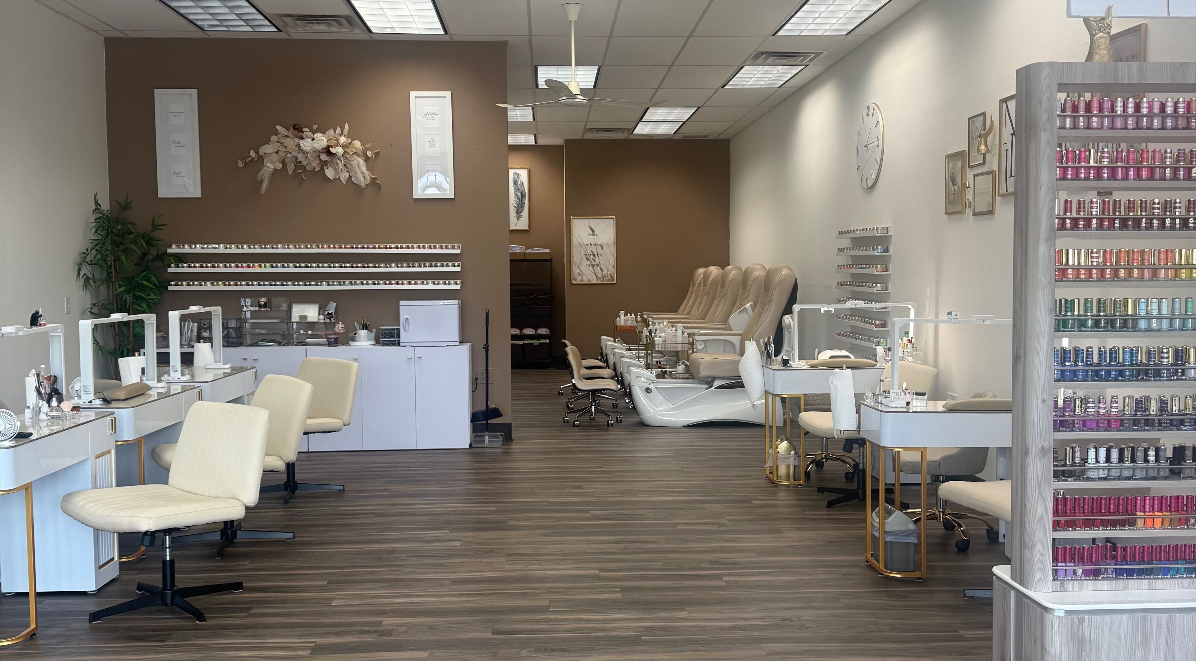 Elegant interior of Emkayy Nails, Neenah, Wisconsin, US, showcasing nail stations and pedicure chairs.