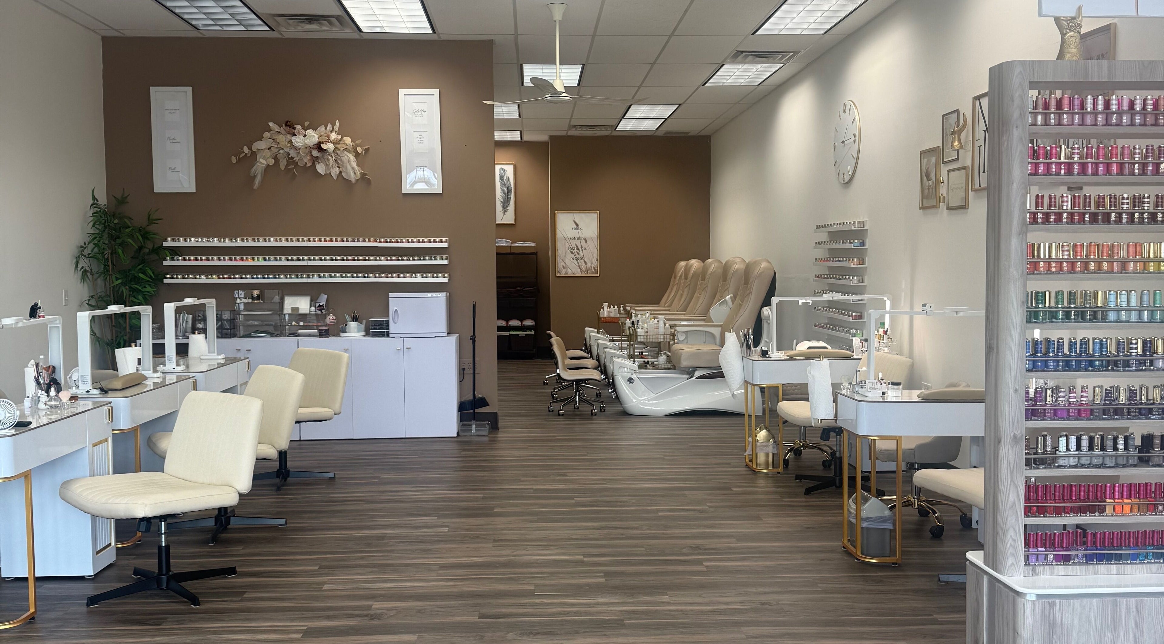 Elegant interior of Emkayy Nails, Neenah, Wisconsin, US, showcasing nail stations and pedicure chairs.