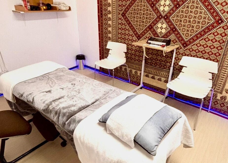 Relaxing massage room at Hands of Healing in Cape Town, Western Cape, ZA featuring cozy decor and calming ambiance.
