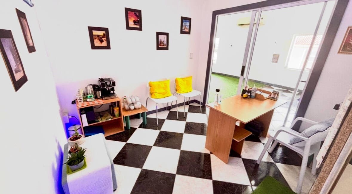 Cozy waiting area at Hands of Healing, Cape Town, Western Cape, ZA with bright decor and coffee station.