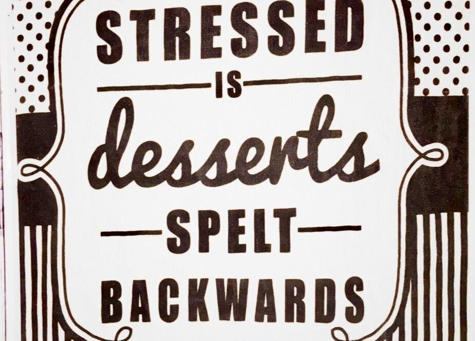 Decorative sign at Hands of Healing, Cape Town, Western Cape, ZA, displaying 'Stressed is desserts spelt backwards'.