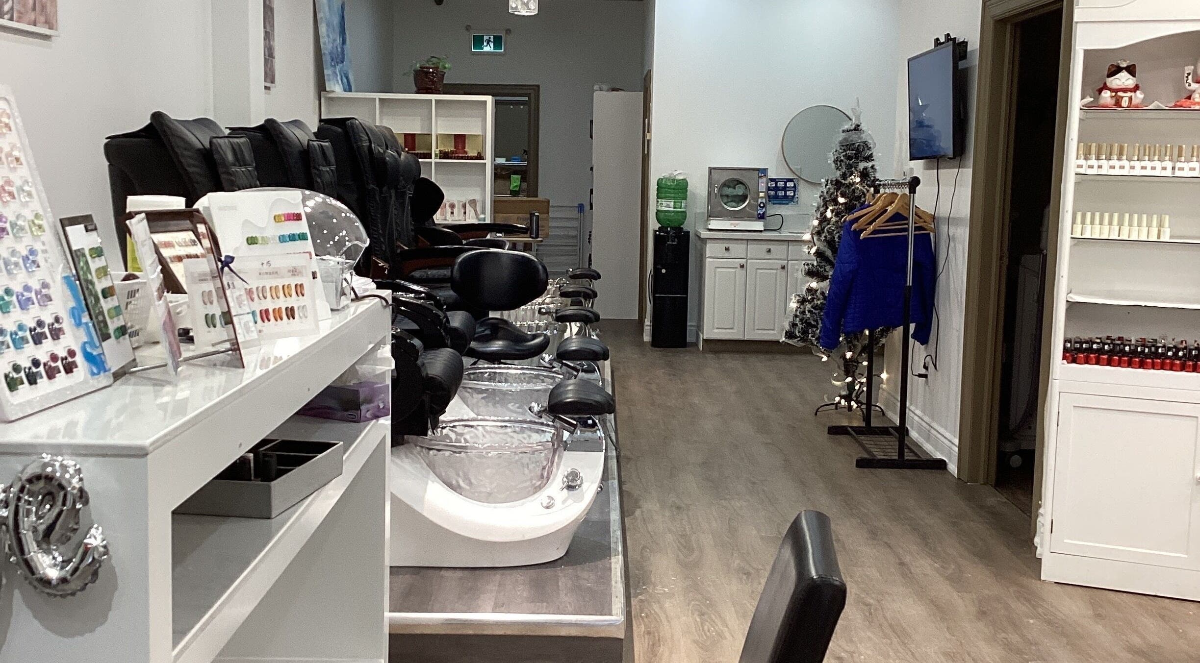 Modern interior of Love Nail Spa in Whitby, Ontario, CA with plush pedicure chairs and elegant decor.