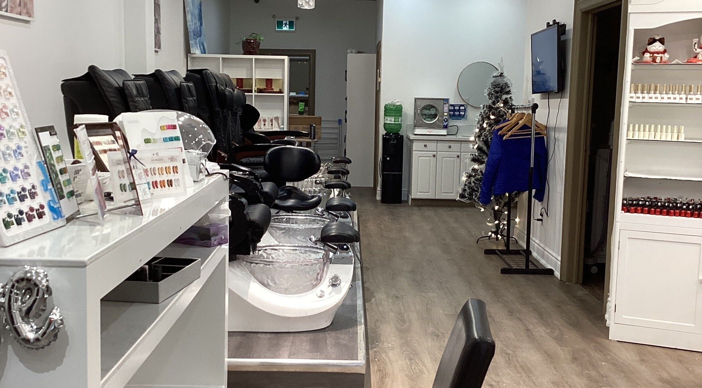 Modern interior of Love Nail Spa in Whitby, Ontario, CA with plush pedicure chairs and elegant decor.