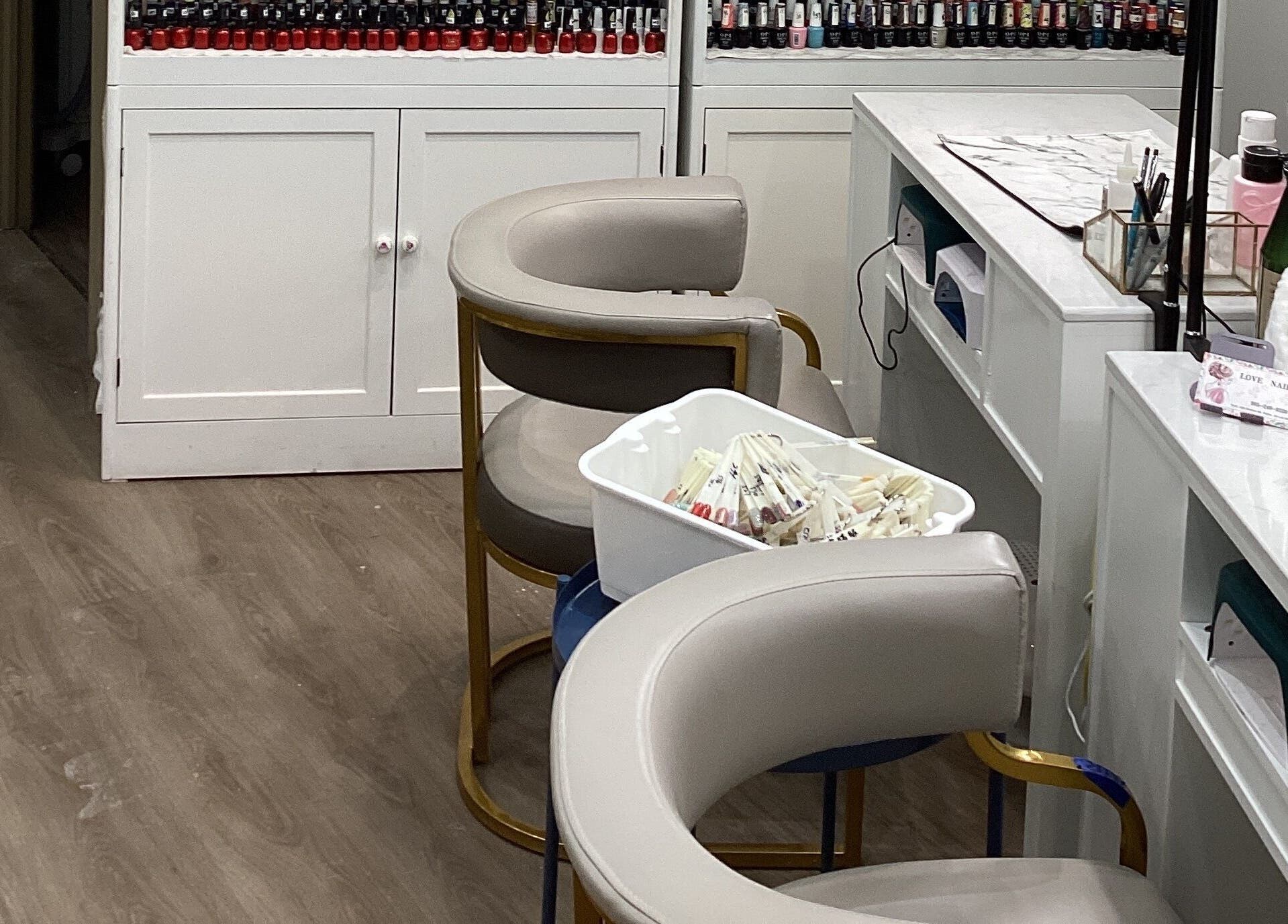 Cozy manicure station at Love Nail Spa, Whitby, Ontario, CA with elegant seating and nail polish display.