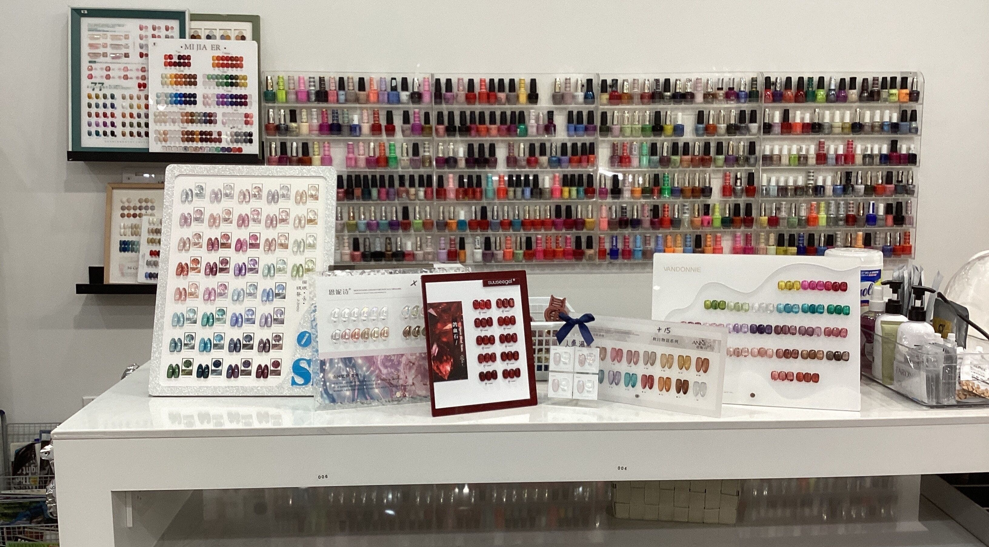 Diverse nail polish collection on display at Love Nail Spa, Whitby, Ontario, CA, showcasing vibrant colors.