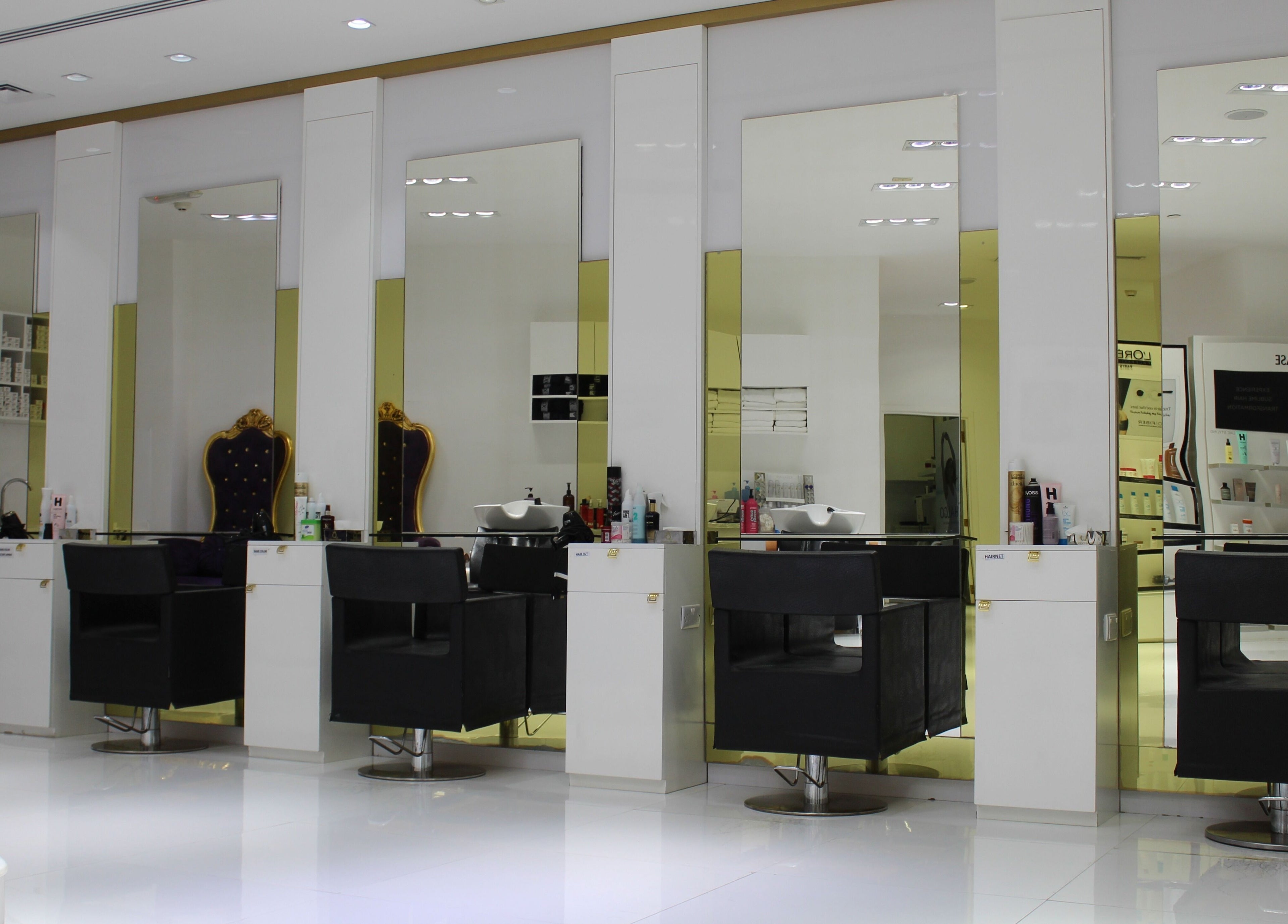 Hush Salon Prive, Dubai, Dubai, AE. Luxurious beauty stations with mirrors and elegant styling chairs.