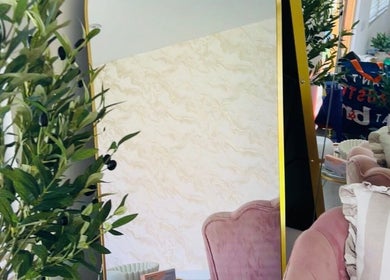 Stylish interior with pink chair and decorative mirror at Glow&co. Skin Lab, Stockton-on-tees, England, GB.