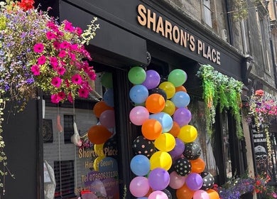 Colorful balloons and flowers decorate LMJ Hair & Makeup Designs in Kilsyth, Scotland, GB.