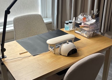 Nail care workspace at By Amelia Ldn, London, England, GB, featuring organized tools and a nail lamp.