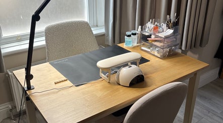 Nail care workspace at By Amelia Ldn, London, England, GB, featuring organized tools and a nail lamp.