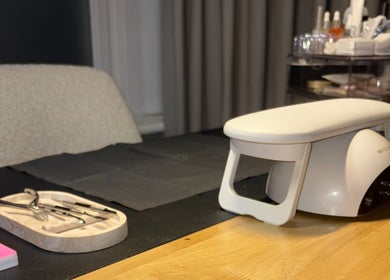 Nail care setup at By Amelia Ldn in London, England, GB, featuring tools and equipment on a wooden table.