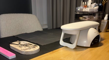 Nail care setup at By Amelia Ldn in London, England, GB, featuring tools and equipment on a wooden table.