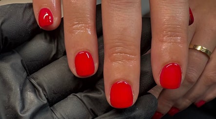 Close-up of vibrant red manicure by By Amelia Ldn in London, England, GB.