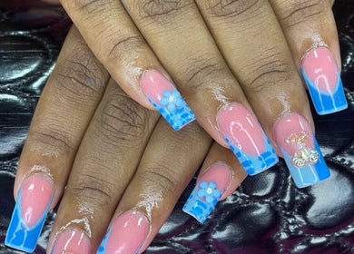 Elegant floral nail art at B’s Beauty Room, Sangre Grande, showcasing blue and pink detailed design.