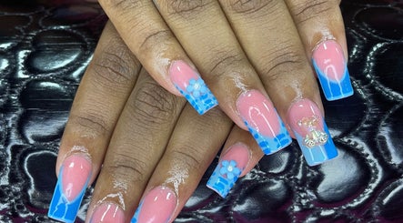 Elegant floral nail art at B’s Beauty Room, Sangre Grande, showcasing blue and pink detailed design.