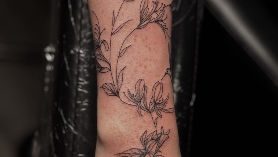 Detailed floral tattoo design at Slyther INK, showcasing arm artistry in Spokane, Washington, US.