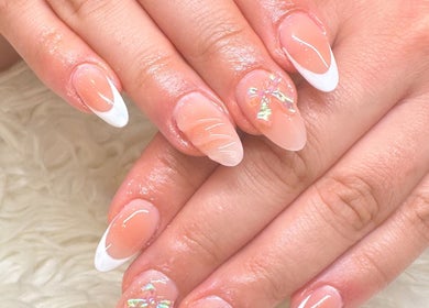 Elegant nail art at Pasea Nail & Spa in Bothell, Washington, US, featuring glossy pink designs with floral accents.