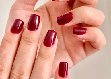 Polished maroon nails from TTS Nails, Norwich, England, GB showcasing expert manicure services.
