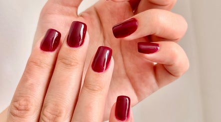 Polished maroon nails from TTS Nails, Norwich, England, GB showcasing expert manicure services.