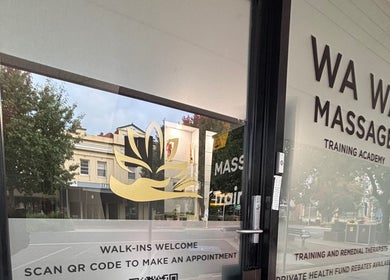 Entrance of WA WA Professional Massage Inverell in New South Wales, showcasing signage and foliage.