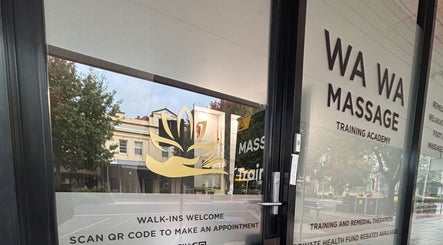 Entrance of WA WA Professional Massage Inverell in New South Wales, showcasing signage and foliage.