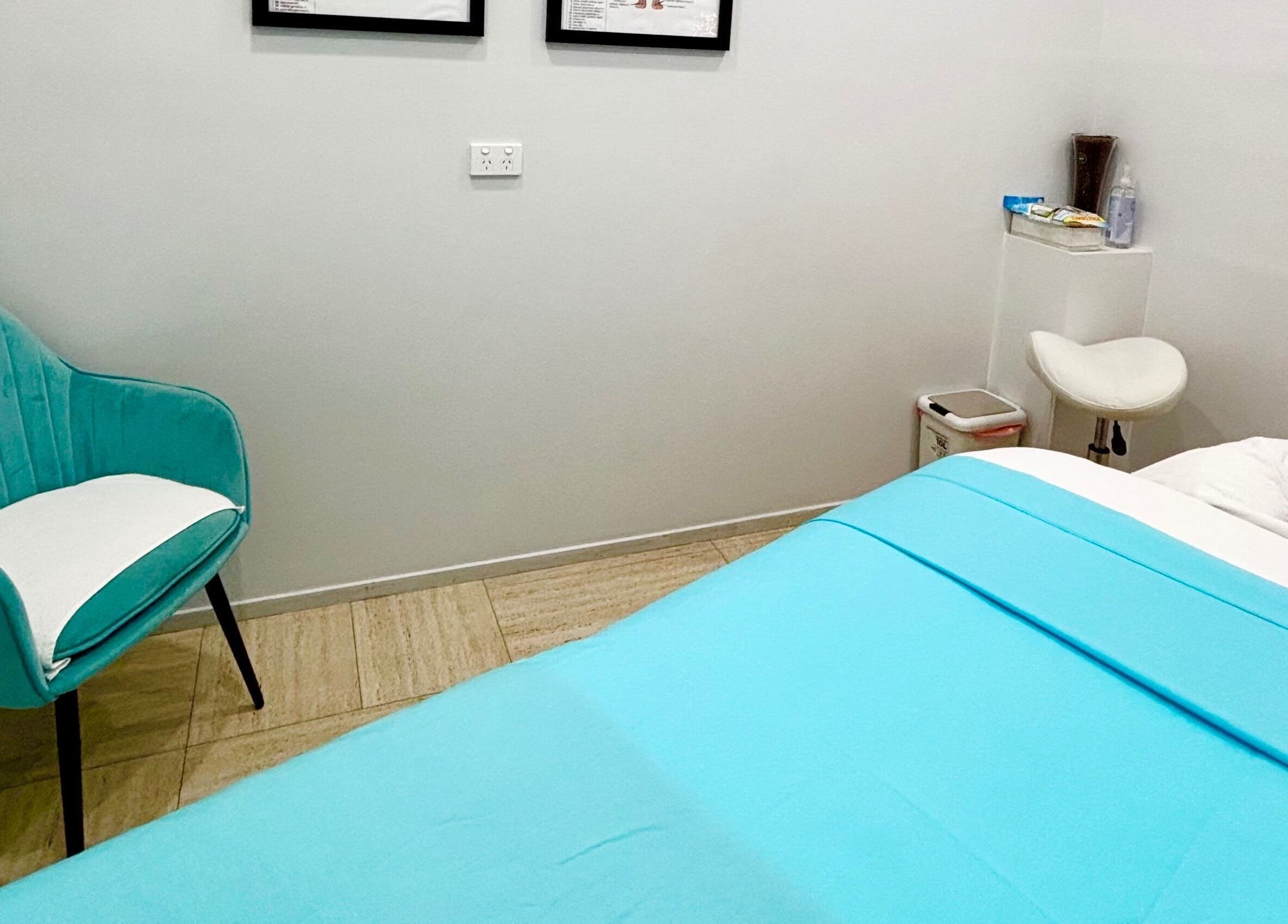 Tranquil massage room at WA WA Professional Massage Inverell, Inverell, New South Wales, AU with a blue bed.