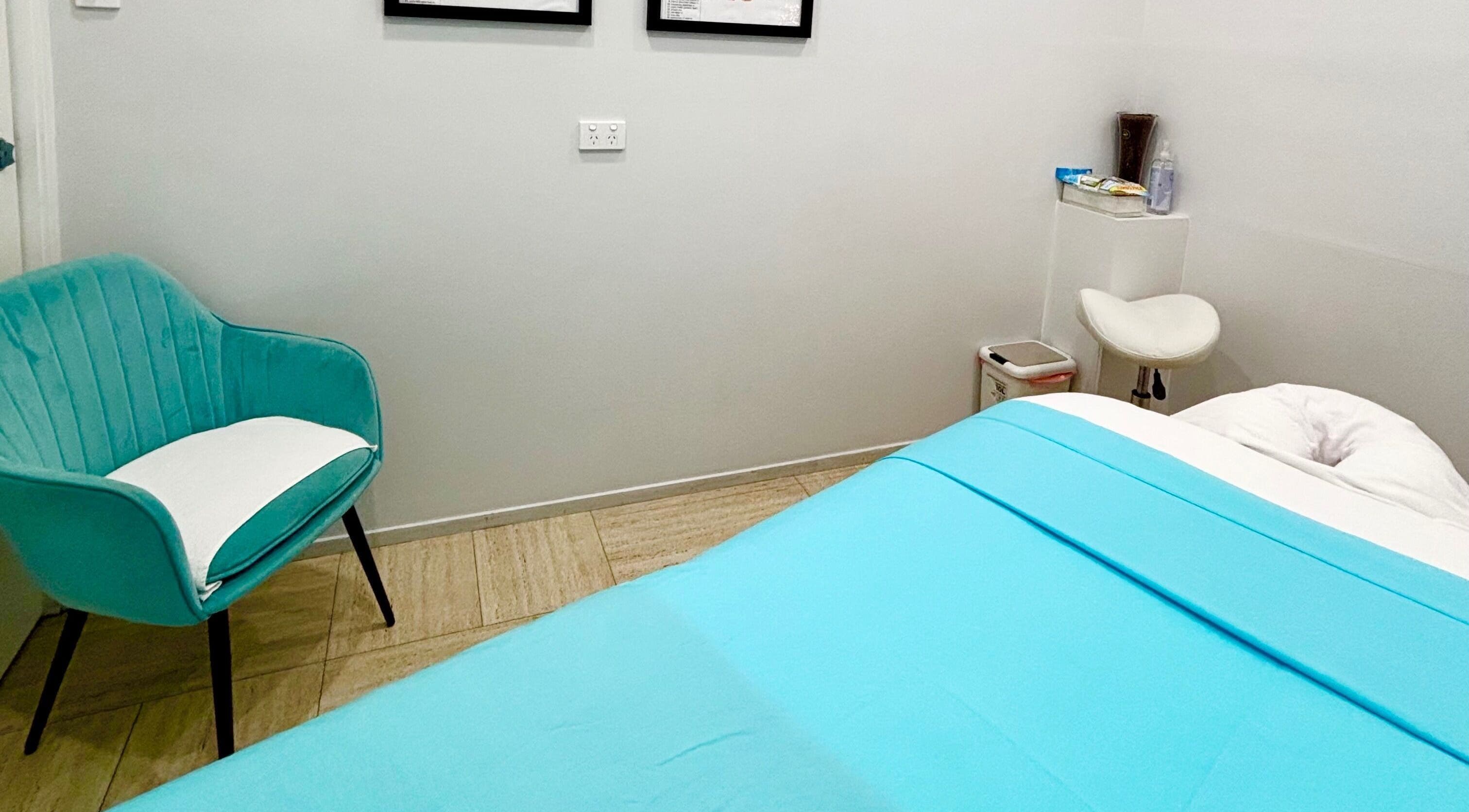 Tranquil massage room at WA WA Professional Massage Inverell, Inverell, New South Wales, AU with a blue bed.