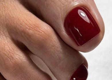 Glossy red toenails at Sasha.B.B.B Nail Studio in Boca Raton, Florida, US showcasing elegant nail art.
