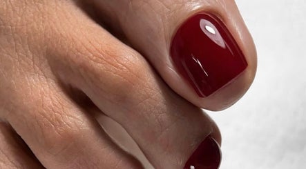 Glossy red toenails at Sasha.B.B.B Nail Studio in Boca Raton, Florida, US showcasing elegant nail art.