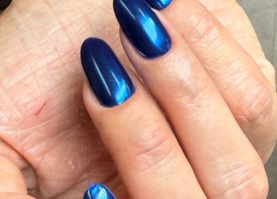Close-up of glossy sapphire nails at Sasha.B.B.B Nail Studio in Boca Raton, Florida, US.