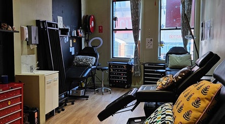 Interior of Kaya Garden Tattoo Haymarket, NSW, AU, showcasing a cozy tattoo studio with seating and decor.