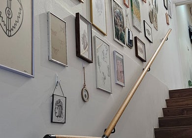 Gallery wall on stairway at Kaya Garden Tattoo Dulwich Hill, artfully displayed, Dulwich Hill, New South Wales, AU.