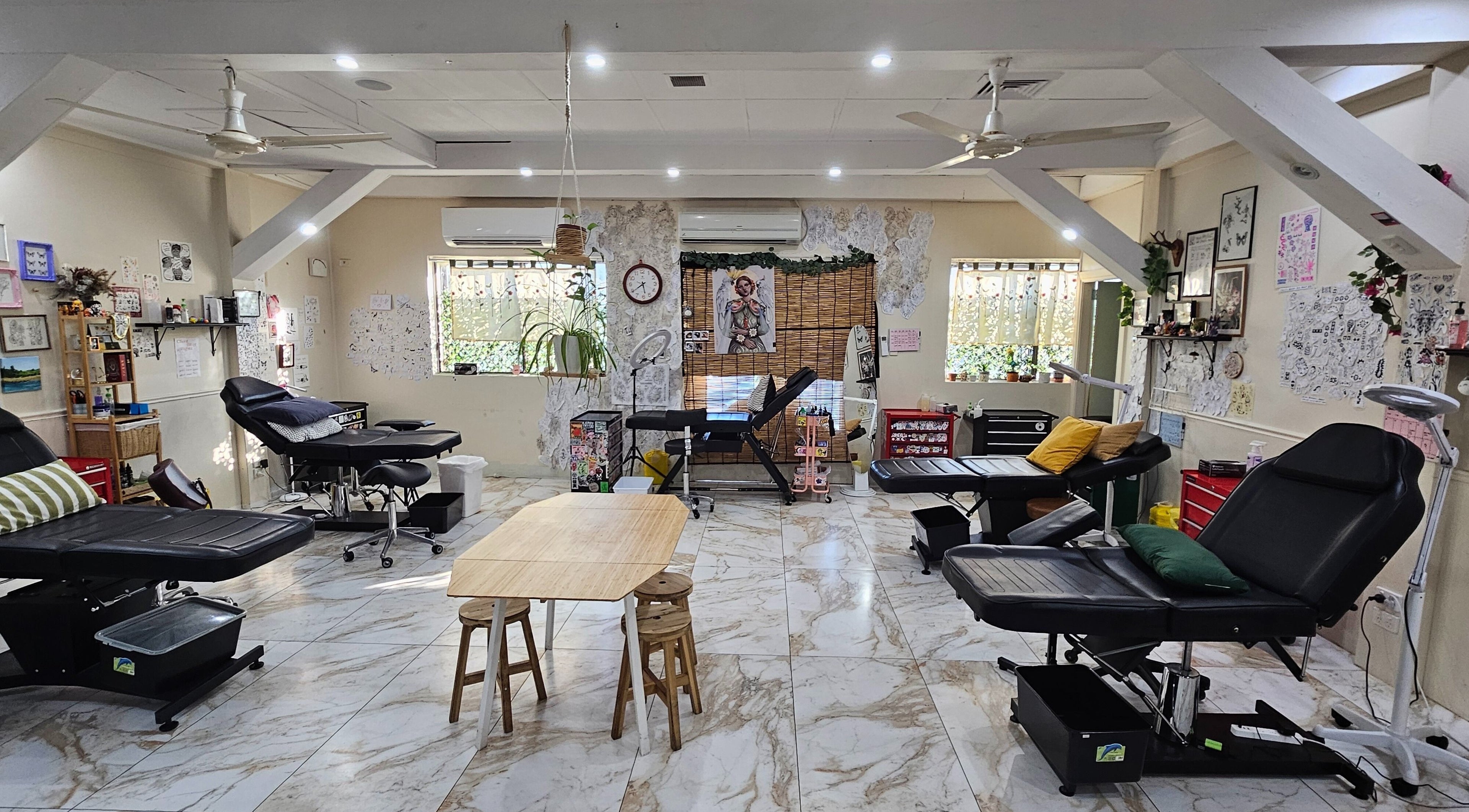 Kaya Garden Tattoo Dulwich Hill interior with art-decorated walls and sleek tattoo chairs in Dulwich Hill, NSW, AU.