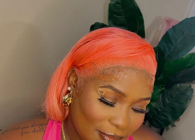 Client with vibrant hairstyle at Allure Beaute’ in St. Johns, AG, showcasing professional beauty services.