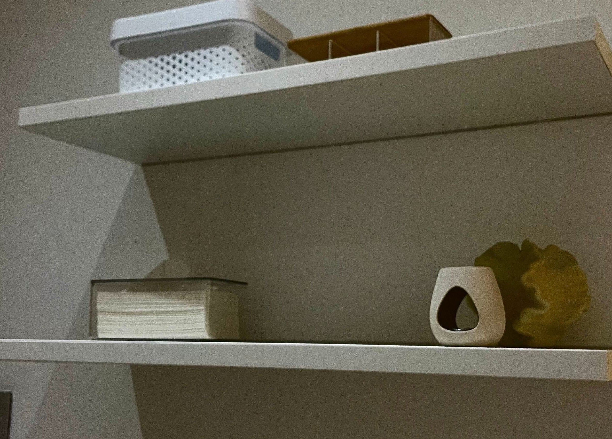 Elegant white shelves with decor at Bella Glow Studio in Windhoek, Khomas Region, NA, enhancing calm ambiance.