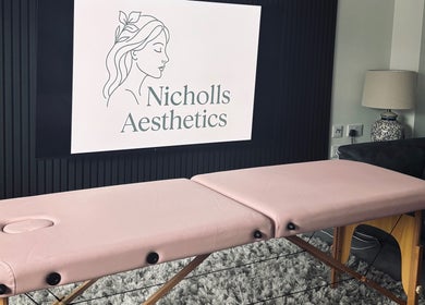 Relaxing treatment room at Nicholls Aesthetics, Burton-on-trent, England, GB featuring a pink massage table.