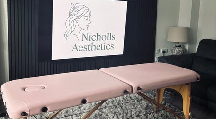 Relaxing treatment room at Nicholls Aesthetics, Burton-on-trent, England, GB featuring a pink massage table.